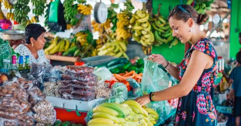 living in belize faqs person buying at san ignacio market