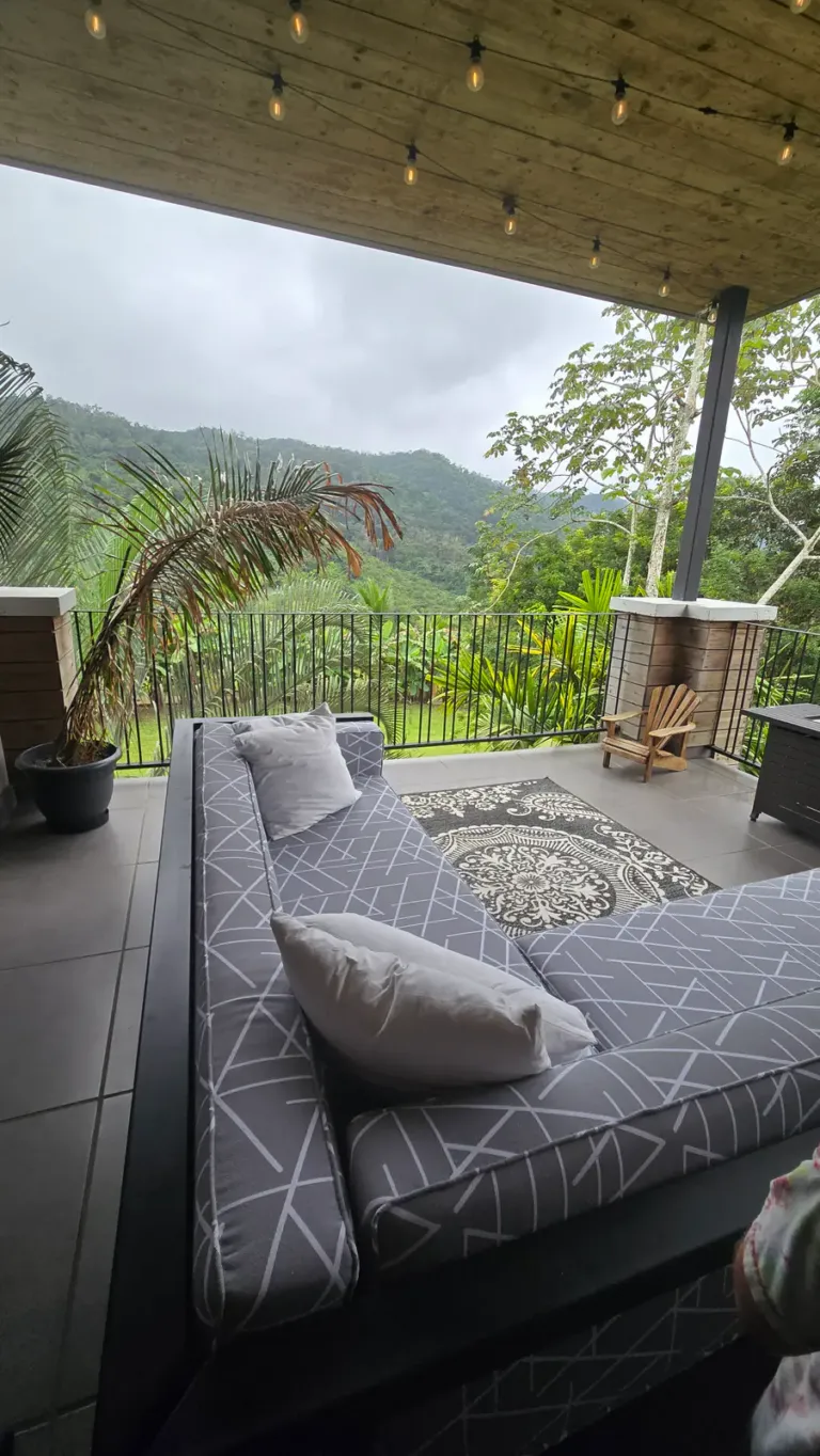 a couch on a patio with a view of the mountains